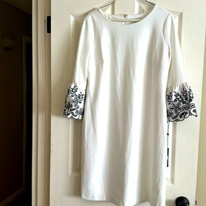 Tommy Hilfiger white dress with black detail at sleeves.